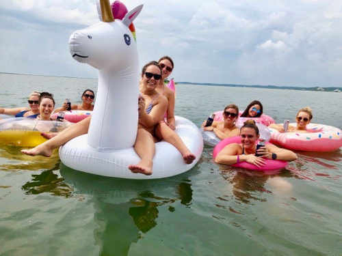 Women riding floats and drinking beer.