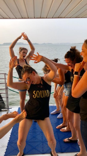 Ladies dancing togather onboard the OC Swim Call.