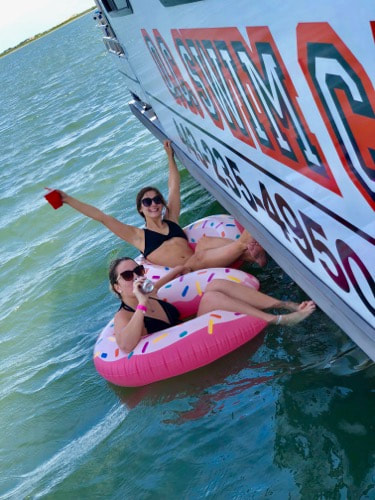 Ladies float next to the OC Swim Call in Ocean City, MD.